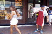 Butcher carries lamb meat for a customer - Tarpon Springs, Florida.