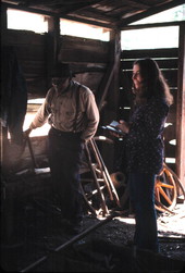Thomas Rains blacksmithing while folklorist Peggy Bulger watches - Monticello, Florida