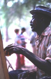 Moses Williams playing the diddley bow at the 1978 Florida Folk Festival