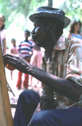 Moses Williams playing the diddley bow at the 1978 Florida Folk Festival