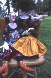 Dolls made by Mildred Bowen sitting on a chair