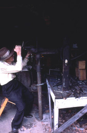 W.H. Hammack working on a metal object- Jasper, Florida