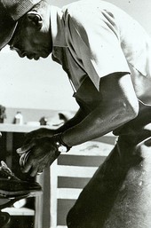 Frank Mitchell polishing a shoe he has just repaired at Capells Shoe Store - Lake City, Florida