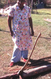Lucreaty Clark during a break from splitting the white oak tree she will use for basket making