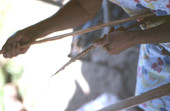 Lucreaty Clark preparing strip of white oak for making baskets