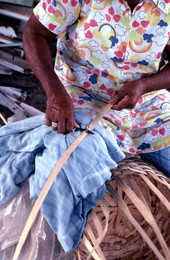 Lucreaty Clark preparing strip of white oak with a small knife during basket making