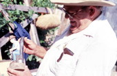 John Albert holding a wood sculpture he made- Tampa, Florida
