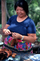 Mary Billie threading a Seminole doll body to prepare for the head - Big Cypress Reservation, Florida