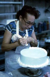 Cuban American woman decorating a cake at the Cafe Cubano in Little Havana - Miami, Florida.
