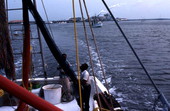 Shrimpers preparing nets while heading out - Fernandina Beach, Florida