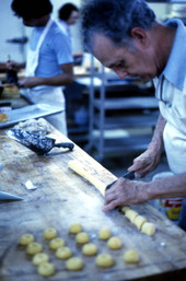 Cuban American man making cookies at Cafe Cubano in Little Havana - Miami, Florida.
