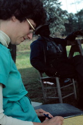 Folklorist Doris J. Dyen taking field notes while filming a video on basket maker Lucreaty Clark- Lamont, Florida