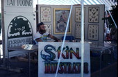 Tattoo artist Jon Fort at his tattoo stand - Pensacola, Florida.