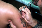 Tattoo artist Jon Fort at work.