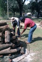 Men getting the firewood ready for a mullet roast - Monticello, Florida