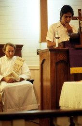 Church attendee reading scripture as Deacon Chuck Bard listens - Seville, Florida