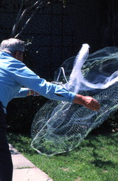 Buddy Maddox showing how to use his cast net - Panama City, Florida.