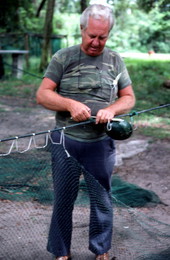 Net maker Martin Cooper repairing a shrimp trawl net - Jacksonville, Florida