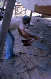 Thomas Herrin painting a boat - Jacksonville, Florida.