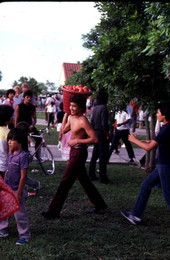 Participant from the Mexican Independence Day tomato picking contest walking with his pail - Florida City, Florida