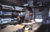 Ramon Puig cutting a pattern to make clothing - Miami, Florida.