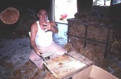 Worker cutting sponges showing his left hand - Miami, Florida.