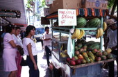 Street vendor selling fruit to Hispanic American women- Miami, Florida.
