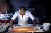 Marty Kaufmann rolling dough to make knishes at Suzanne's Foods - Miami, Florida.