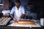 Marty Kaufmann rolling dough to make knishes at Suzanne's Foods - Miami, Florida.