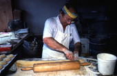 Marty Kaufmann cutting dough to make knishes at Suzanne's Foods - Miami, Florida.
