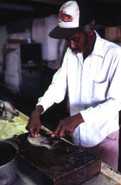 Clay Vioria cleaning fish at Toranto's Fish House - Apalachicola, Florida.