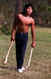 Boy playing stick ball - Big Cypress Reservation, Florida