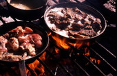 Dinner cooking on open fire at Rosie and Alice Billie's family camp - Ochopee, Florida