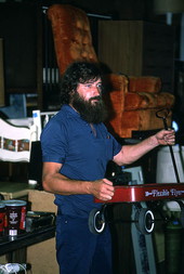 Furniture store personnel holding up toy wagon as handler during auction - Jacksonville, Florida