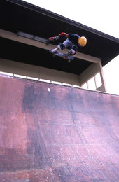 Skateboarder on a half pipe performing aerial moves - Jacksonville, Florida.