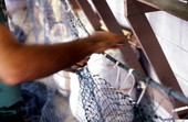 Rickey Doublerly knitting a fishing net - Jacksonville, Florida