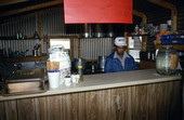 Hiram Jenkins working behind the counter at his barbecue restaurant - Jacksonville, Florida