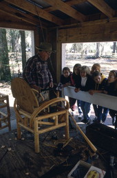 Robert James Rudd giving a cypress furniture making demonstration to school children - White Springs, Florida