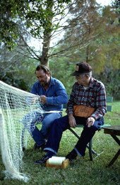 Reginald Reis making a cast net while Max Dooley observes - Lakeland, Florida