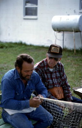 Reginald Reis making a cast net while Max Dooley observes - Lakeland, Florida