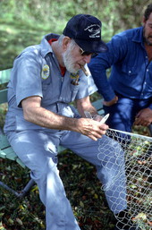 Max Dooley showing apprentice Reginald Reis how to make a cast net - Lakeland, Florida