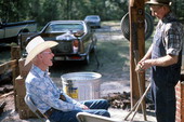 Horace Temples chatting with T.G. Mayo while syrup cooks - White Springs, Florida
