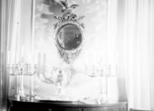 Mirror, silver candlesticks and silver urn
