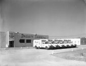 Delivery trucks parked in front of Bassett Dairies building