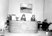 Two women employees at desk in Tallahassee office of National Airlines