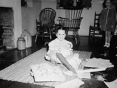 Mary Call Collins opening presents at her birthday party
