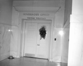 Black wreath hangs on door to Governor's Office following death of Dan McCarty.