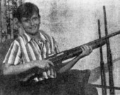 Billy Ben Holland holding a shotgun
