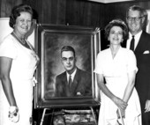 Family members and artist pose with painted portrait of Governor McCarty - Tallahassee, Florida.