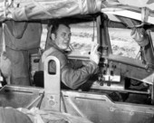 Governor Claude Kirk giving the peace/victory sign from the controls